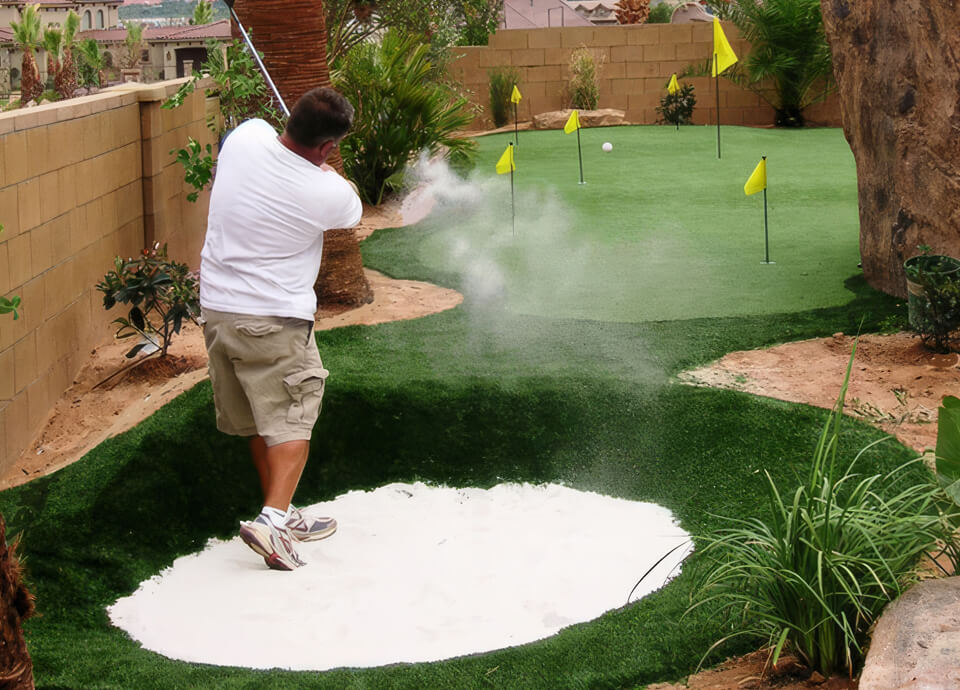 Synthetic grass putting green with real sand bunker in Phoenix side yard