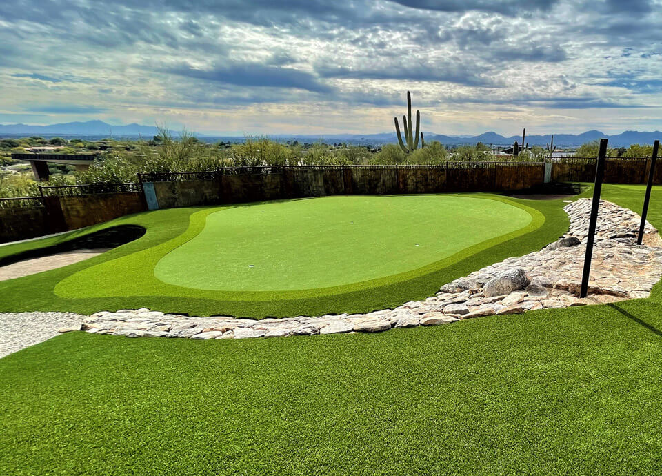 Backyard putting green with Phoenix desert in background