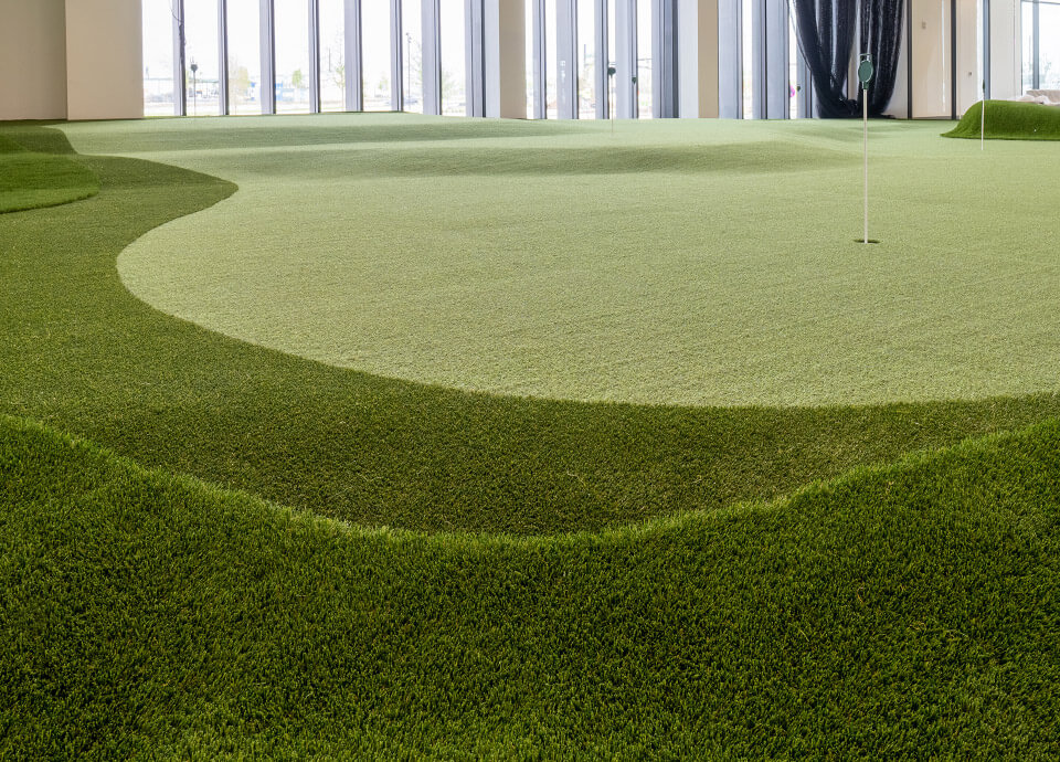 Indoor putting green with multiple levels and undulations